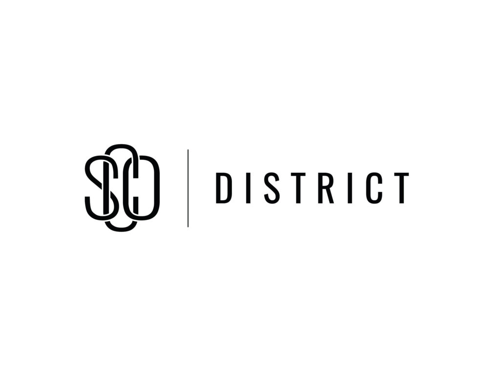 Logo of SCD District featuring stylized "SCD" letters on the left and the word "DISTRICT" in uppercase on the right, separated by a vertical line. The design is in black on a white background.